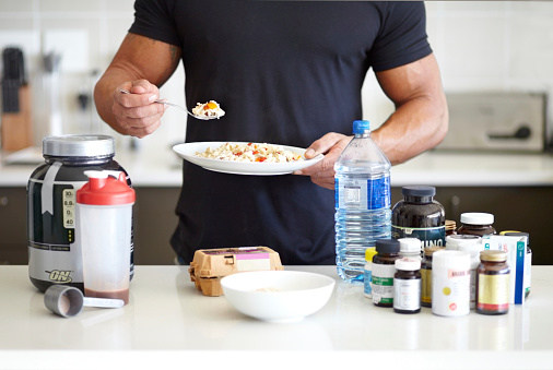 body builder in-taking fitness supplements